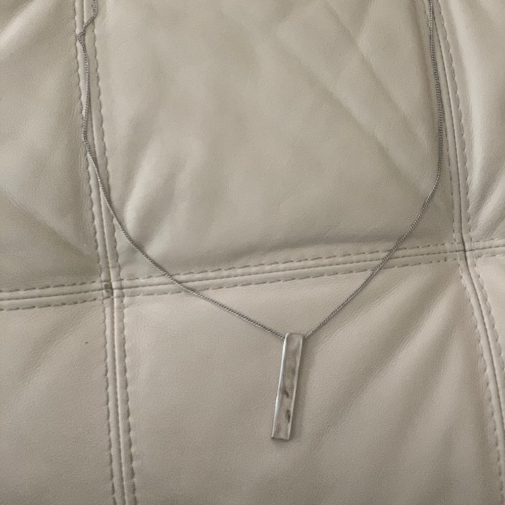 34 inch silver colored necklace.